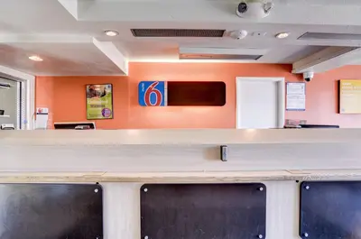 a bar in a waiting room with orange walls at Motel 6-Greenwood Village, CO - Denver - South Tech Center in Greenwood Village