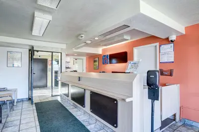 a bar in a restaurant with orange walls at Motel 6-Greenwood Village, CO - Denver - South Tech Center in Greenwood Village