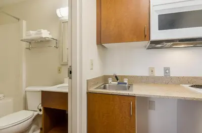 a small bathroom with a sink and a toilet at HomeTowne Studios by Red Roof Denver - Glendale/ Cherry Creek in Denver
