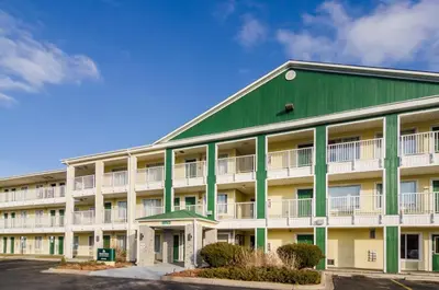 a large apartment building with a green roof at HomeTowne Studios by Red Roof Denver - Glendale/ Cherry Creek in Denver