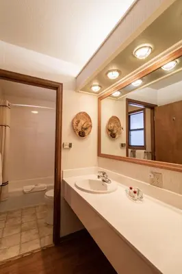 a bathroom with a sink and a mirror at Wildwood Inn in Estes Park