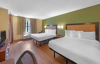 a hotel room with two beds and a television at Extended Stay America Suites - Denver - Tech Center South - Inverness in Centennial