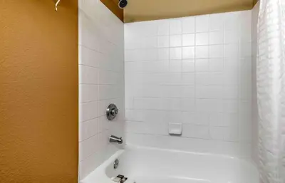 a bathroom with a white tub and a shower at Extended Stay America Suites - Denver - Tech Center South - Inverness in Centennial