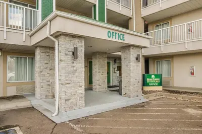 an office building with a sign in front of it at HomeTowne Studios by Red Roof Denver - Airport/Aurora in Aurora