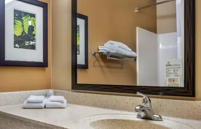 a bathroom with a sink with a mirror and towels at Extended Stay America Suites - Denver - Aurora North in Aurora