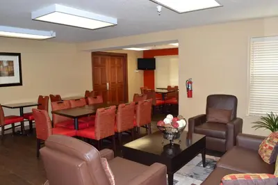 a waiting room with chairs and a table and a couch at Extended Stay America Suites - Denver - Aurora North in Aurora