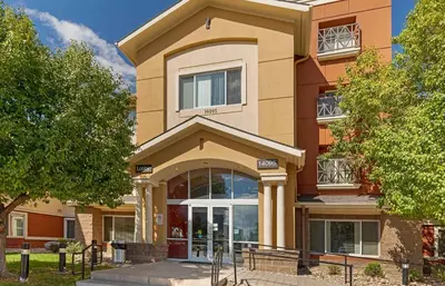 a building with a large door in front of it at Extended Stay America Suites - Denver - Aurora North in Aurora