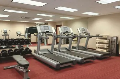 a gym with several tread machines in a room at Hyatt House Denver Tech Center in Centennial