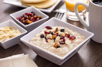 a bowl of oatmeal with fruit and nuts on a table at Hyatt House Denver Tech Center in Centennial