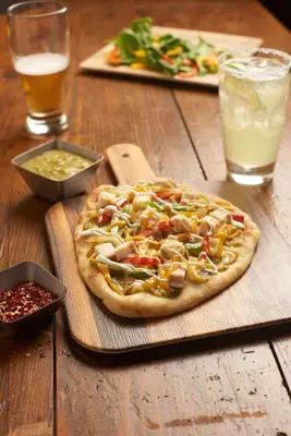 a pizza sitting on top of a wooden table at Hyatt House Denver Tech Center in Centennial