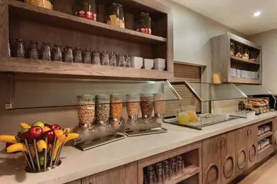 a kitchen with a counter with some food at Hyatt House Denver Tech Center in Centennial