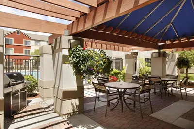 a patio with a table and chairs and a grill at Hyatt House Denver Tech Center in Centennial