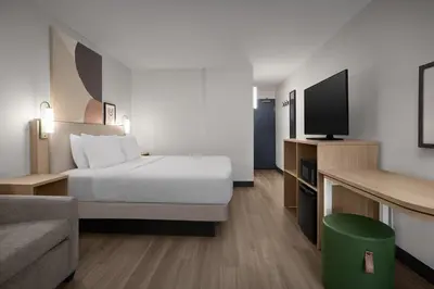 a hotel room with a bed and a tv at Spark by Hilton Denver East I 70 in Denver