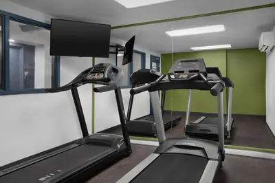 a gym with two tread machines in a room at Spark by Hilton Denver East I 70 in Denver
