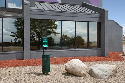 a parking meter in front of a building with two rocks at Spark by Hilton Denver East I 70 in Denver