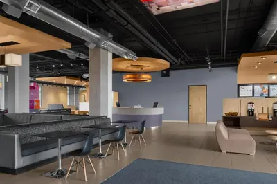 a lobby with tables and chairs in a building at Aloft Broomfield Denver in Broomfield