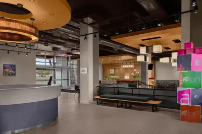 a lobby of a restaurant with a bench at Aloft Broomfield Denver in Broomfield