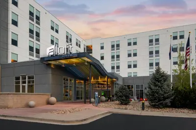 a hotel building with a sign on the front of it at Aloft Broomfield Denver in Broomfield