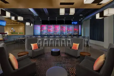 a conference room with chairs and a stage at Aloft Broomfield Denver in Broomfield