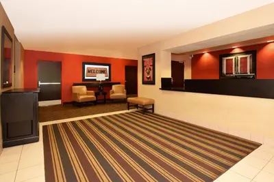 a lobby with red walls and a waiting room at Extended Stay America Select Suites - Denver - Tech Center - Central in Greenwood Village