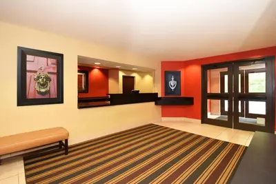 a waiting room with red walls and a mirror at Extended Stay America Select Suites - Denver - Tech Center - Central in Greenwood Village