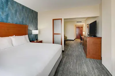 a hotel room with a bed and a flat screen tv at Drury Plaza Hotel Denver Westminster in Westminster