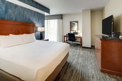 a hotel room with a bed and a desk at Drury Plaza Hotel Denver Westminster in Westminster