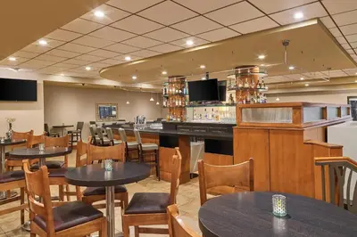 a restaurant with tables and chairs and a bar at Sheraton Hotel Denver Tech Center in Greenwood Village