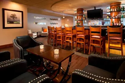 a bar with chairs and a table in a room at Sheraton Hotel Denver Tech Center in Greenwood Village