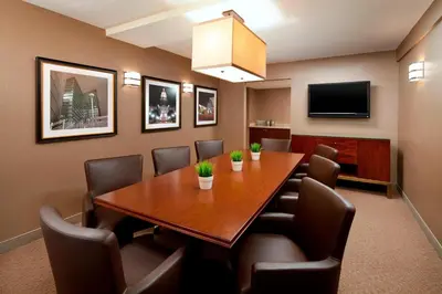 a conference room with a wooden table and chairs at Sheraton Hotel Denver Tech Center in Greenwood Village