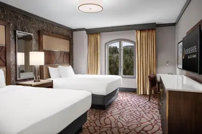 a hotel room with two beds and a sink at Horseshoe Black Hawk, A Caesars Destination in Black Hawk