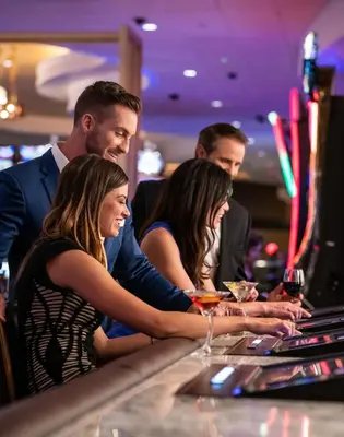 a group of people sitting at a bar at Horseshoe Black Hawk, A Caesars Destination in Black Hawk