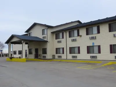 a building with a parking lot in front of it at Travelodge by Wyndham Longmont in Longmont