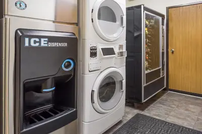 a washer and dryer next to a refrigerator at Travelodge by Wyndham Longmont in Longmont