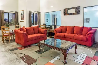a living room with two couches and a coffee table at Travelodge by Wyndham Longmont in Longmont