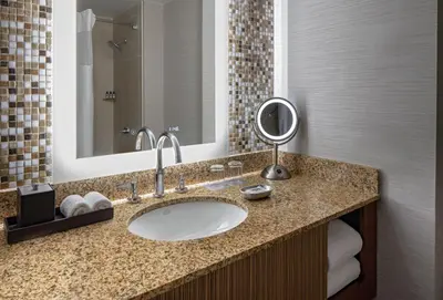 a bathroom with a sink and a mirror at Hyatt Regency Denver Tech Center in Denver
