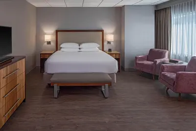 a hotel room with a bed and two chairs at Hyatt Regency Denver Tech Center in Denver