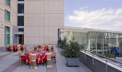 a patio with tables and chairs and a building at Hyatt Regency Denver at Colorado Convention Center in Denver