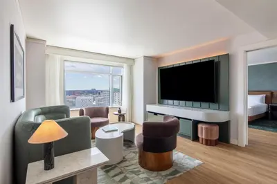 a living room with a television and a living room with a bed at Hyatt Regency Denver at Colorado Convention Center in Denver