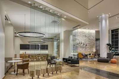 a lobby with tables and chairs in a building at Hyatt Regency Denver at Colorado Convention Center in Denver