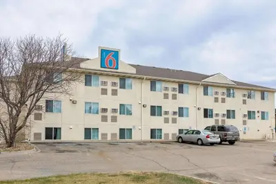 a hotel with a sign on top of a building at Motel 6-Fort Lupton, CO in Fort Lupton