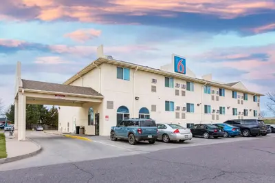 a hotel with cars parked in front of it at Motel 6-Fort Lupton, CO in Fort Lupton