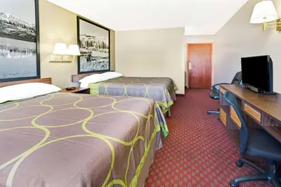 a hotel room with two beds and a desk at Super 8 by Wyndham Longmont/Del Camino in Longmont