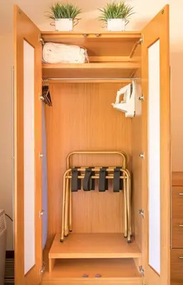 a room with a closet with towels and plants at Alpine Trail Ridge Inn in Estes Park