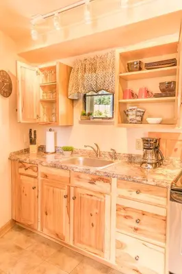 a kitchen with wooden cabinets and a sink at Alpine Trail Ridge Inn in Estes Park
