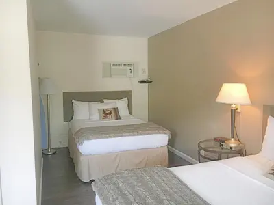 a hotel room with two beds and a lamp at Alpine Trail Ridge Inn in Estes Park