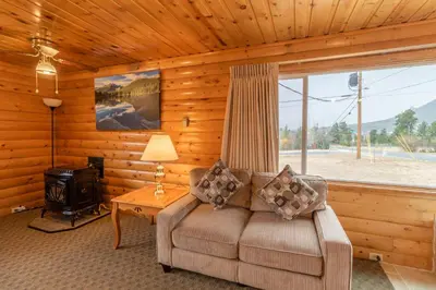 a living room with a couch and a stove at Blue Door Inn in Estes Park