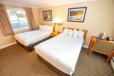 a hotel room with two beds and a window at Blue Door Inn in Estes Park