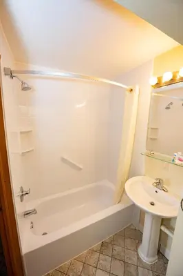 a bathroom with a bath tub and a sink at Blue Door Inn in Estes Park