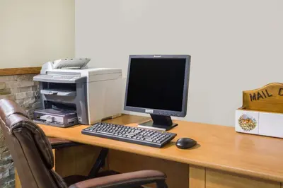 a desk with a computer and a printer on it at Travelodge by Wyndham Loveland/Fort Collins Area in Loveland